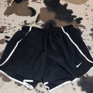 Black Nike shorts with white piping